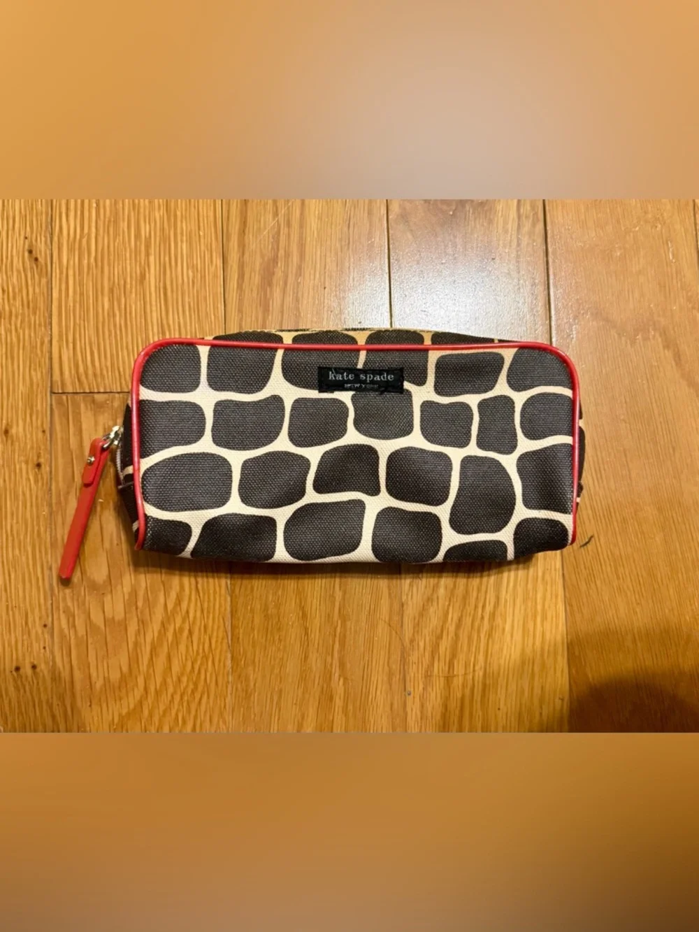 Kate Spade New York cosmetic bag or pencil case featuring a signature giraffe-